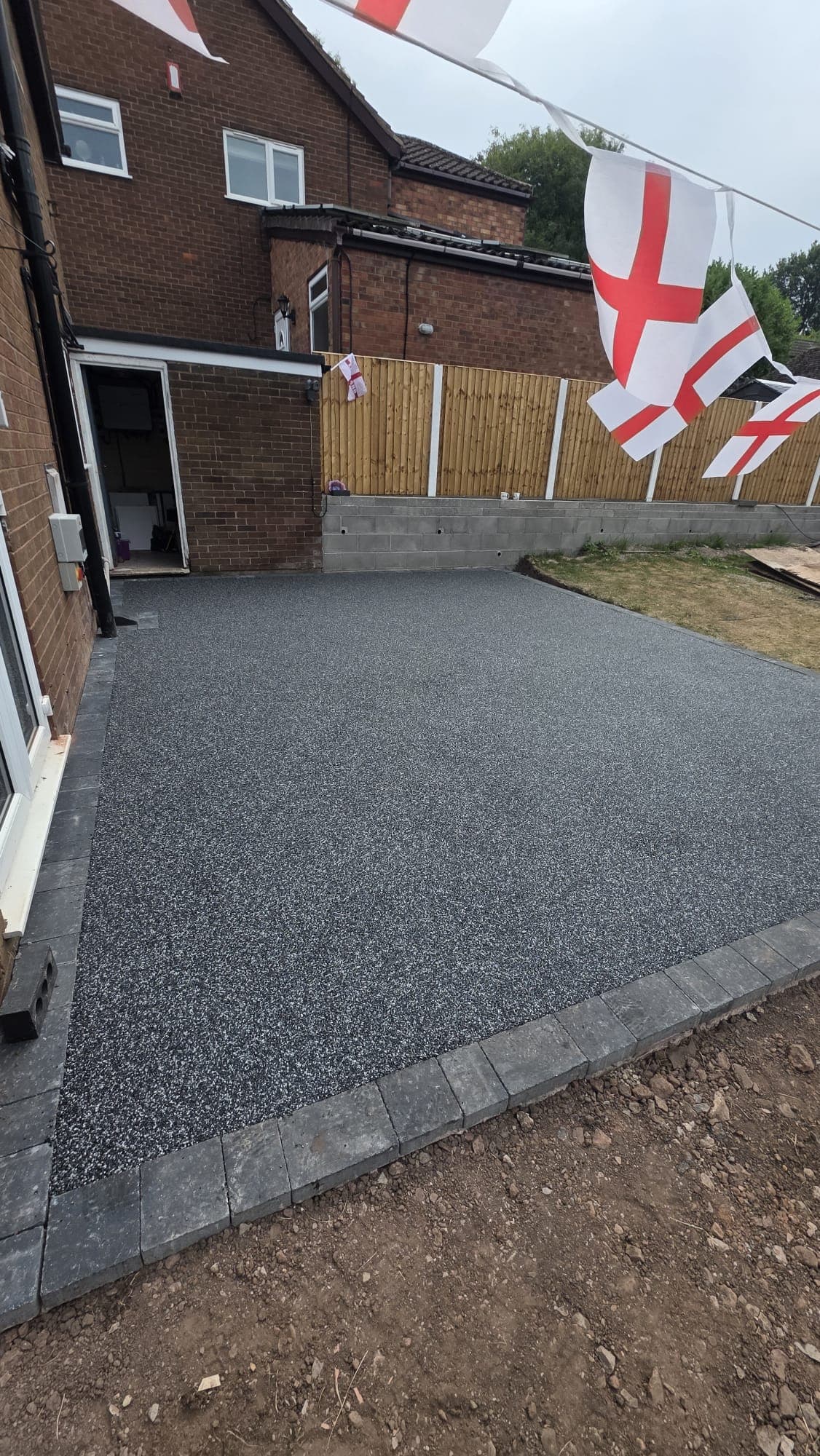 Completed grey resin patio with block edging by Tru-Pro Landscapes